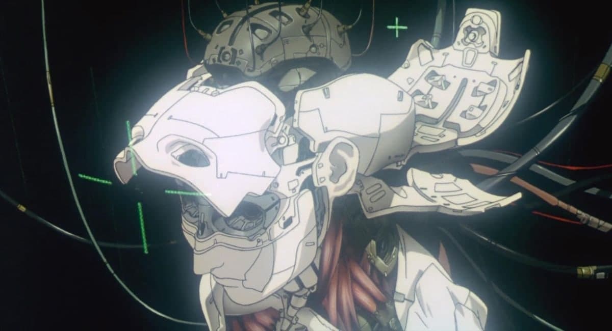 A cybernetic body suspended and assembled in darkness, wires trailing, the body revealed as machine